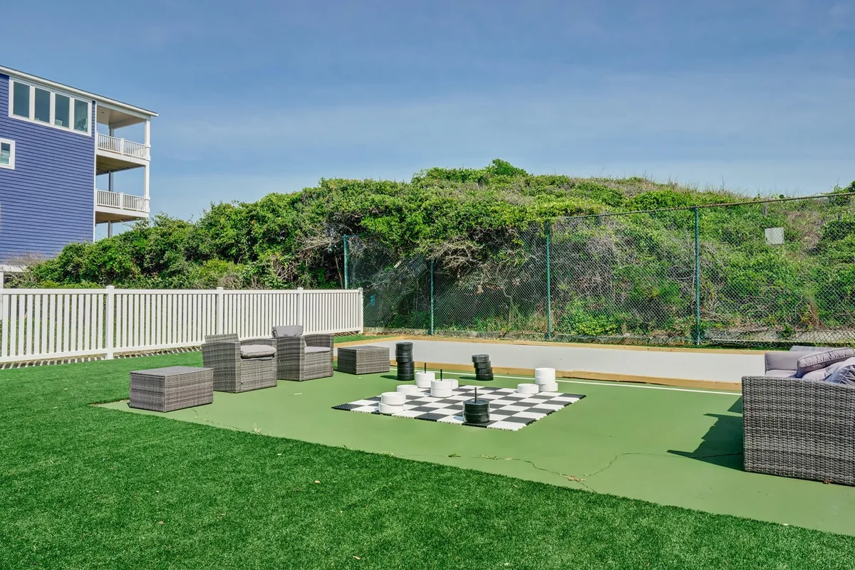 An inviting outdoor space with a life-sized chess set, comfortable seating, and lush landscaping. The playful atmosphere encourages guests to take breaks for leisure activities, socialize with colleagues or fellow travelers, and enjoy the natural surroundings.